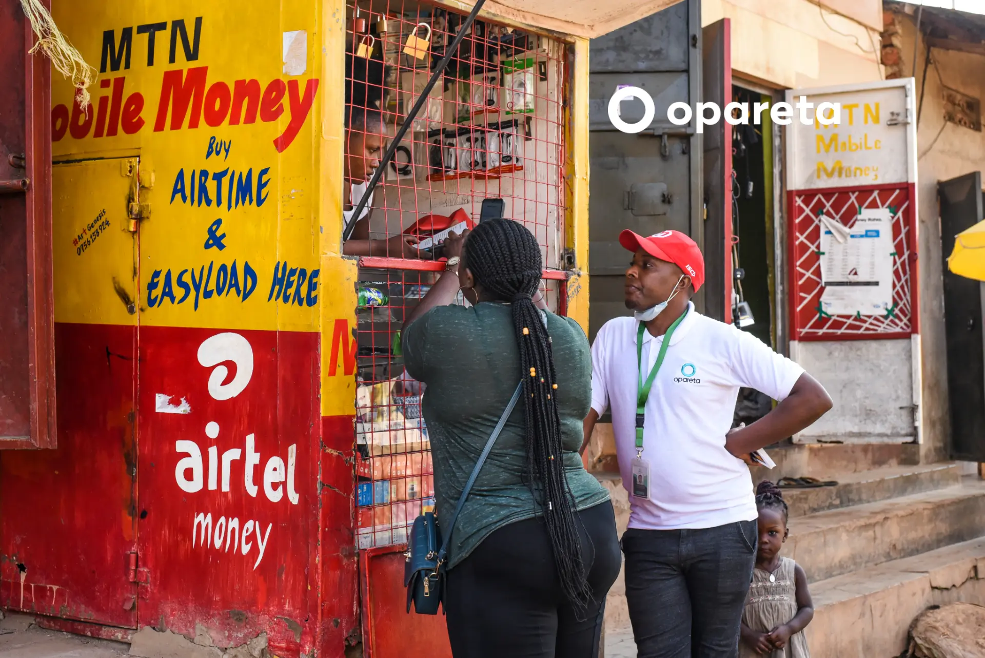 An Opareta field agent supporting a mobile money agent